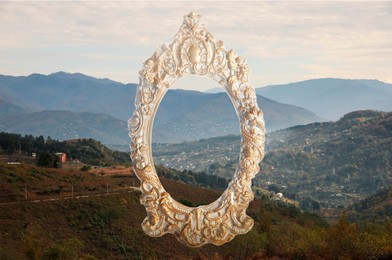 Image of Vintage frame and beautiful mountains under cloudy sky