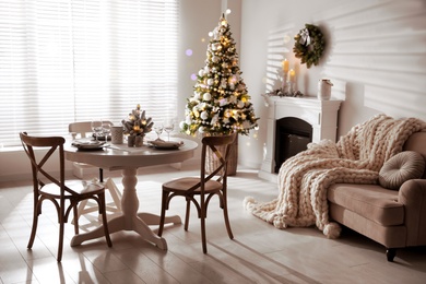 Image of Festive table setting and beautiful Christmas decor in living room. Interior design