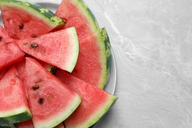 Photo of Slices of tasty ripe watermelon on light grey marble table, top view