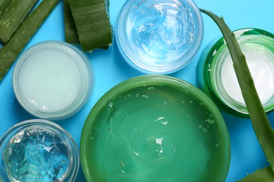 Photo of Aloe and different cosmetic products on light blue background, flat lay