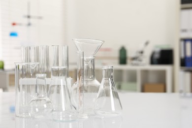 Laboratory analysis. Different glassware on white table indoors, space for text