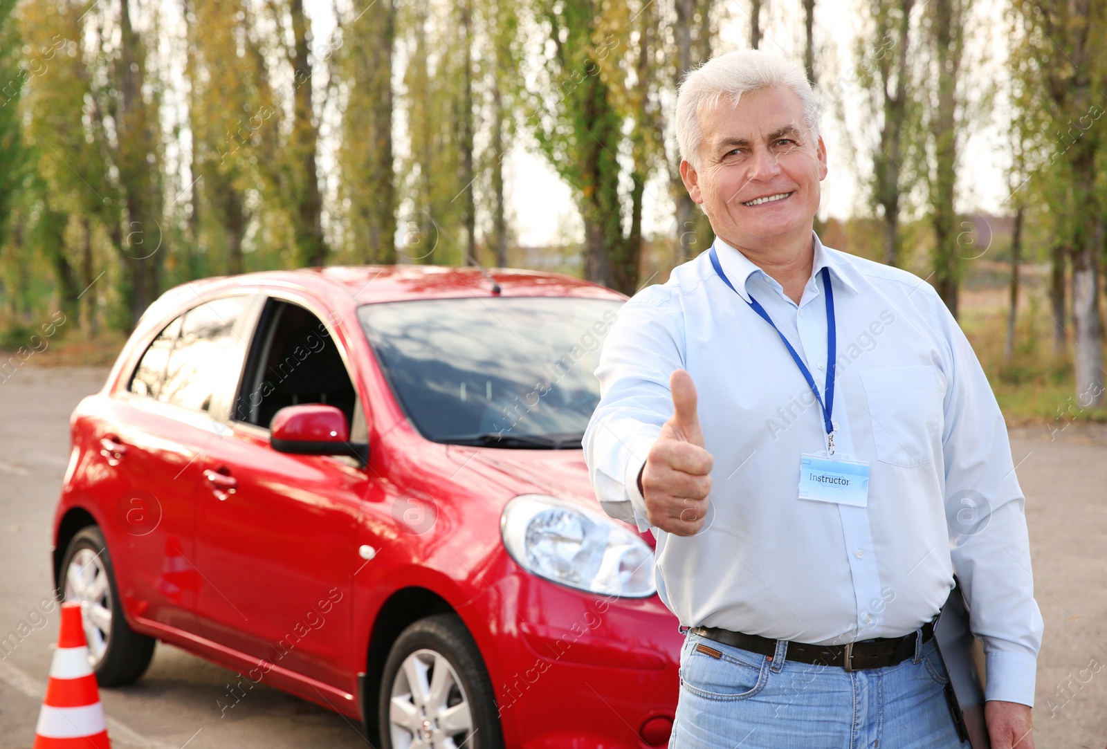 Photo of Senior instructor near modern car outdoors. Get driving license