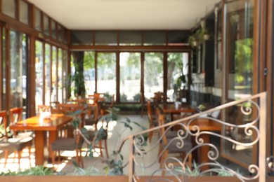 Photo of Blurred view of modern cafe with outdoor terrace