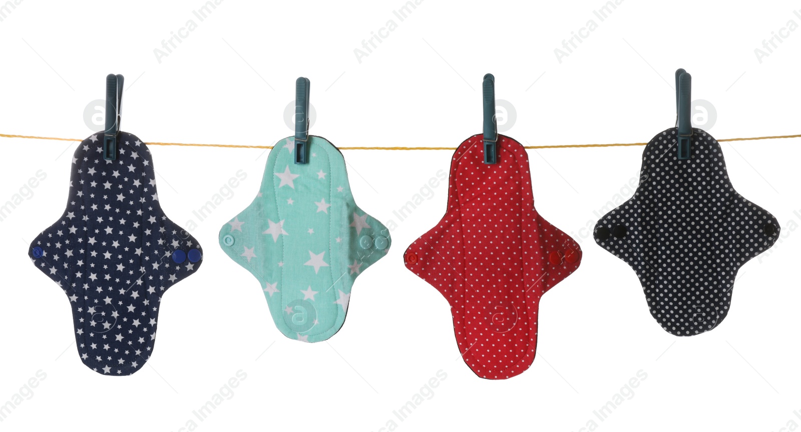 Photo of Many different cloth menstrual pads hanging isolated on white