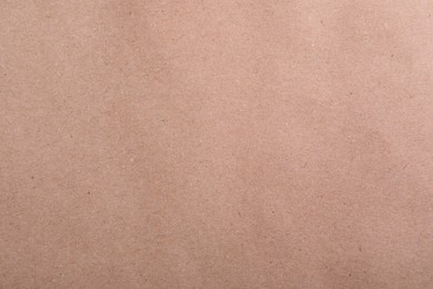 Photo of Texture of kraft paper bag as background, closeup