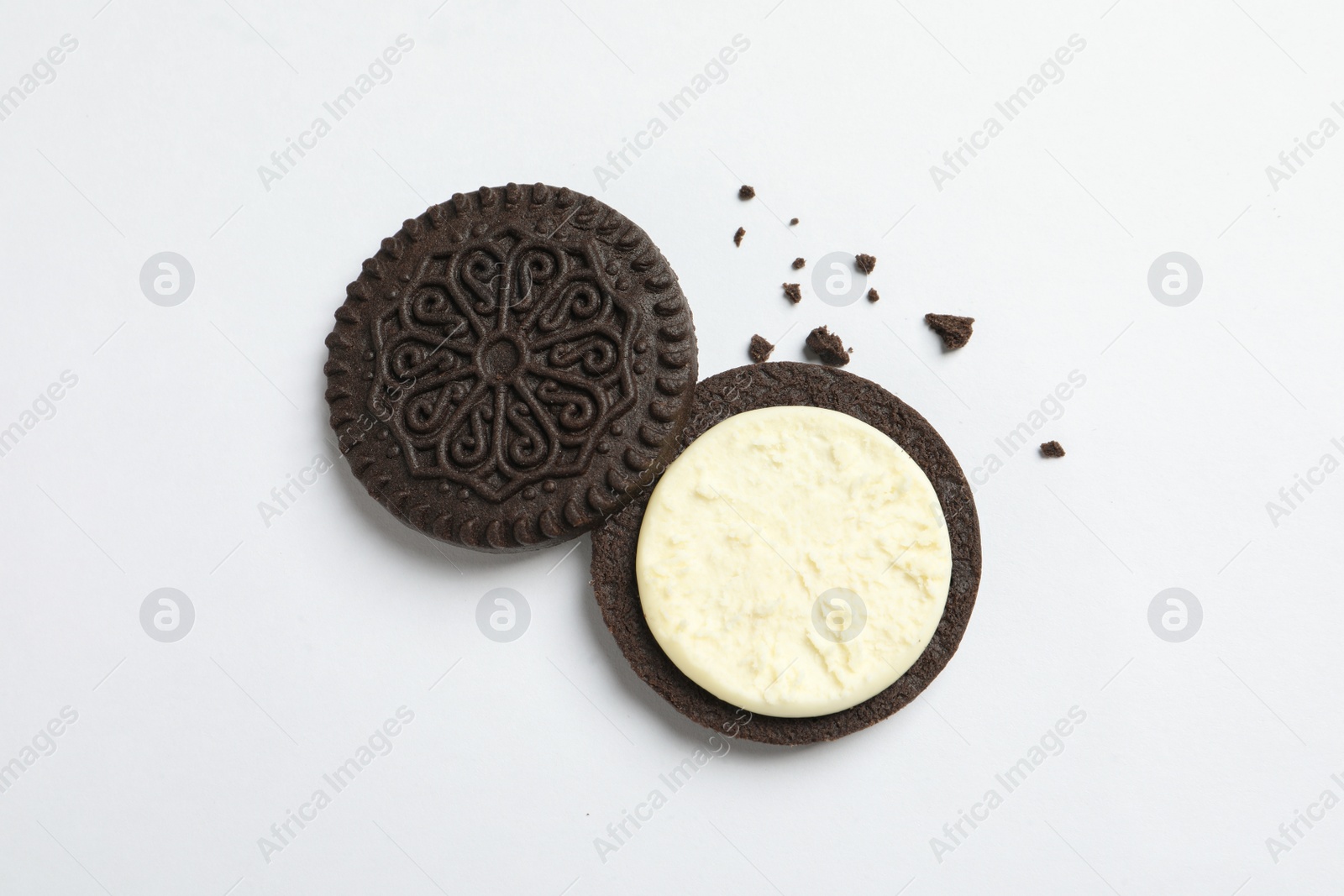 Photo of Tasty chocolate cookie with cream on white background, top view