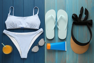 Photo of Flat lay composition with beach objects on blue wooden background