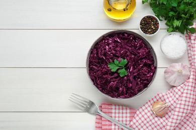 Photo of Tasty red cabbage sauerkraut with parsley and different ingredients on white wooden table, flat lay. Space for text