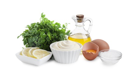 Photo of Fresh mayonnaise sauce in bowl and ingredients on white background