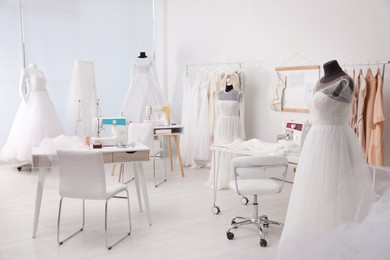 Photo of Dressmaking workshop interior with wedding dresses and equipment