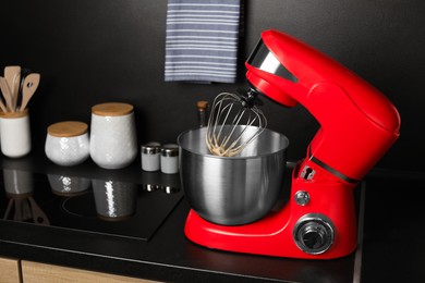 Photo of Modern stand mixer on countertop in kitchen. Home appliance