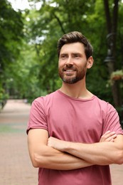 Portrait of handsome bearded man in park