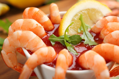 Photo of Delicious shrimp cocktail with tomato sauce, closeup