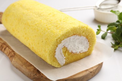 Delicious cake roll on white table, closeup