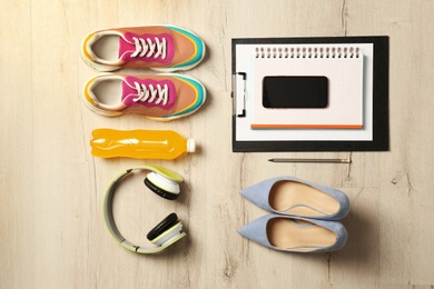 Flat lay composition with business items and sport accessories on wooden background. Concept of balance between work and life