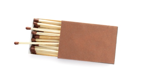 Photo of Cardboard box with matches on white background, top view. Space for design