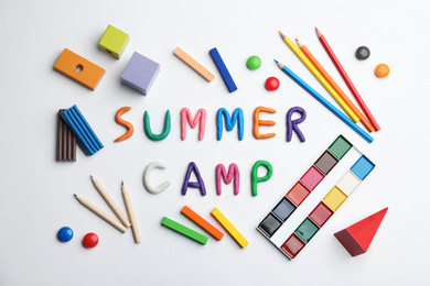 Photo of Flat lay composition with phrase SUMMER CAMP made of colorful clay on white background