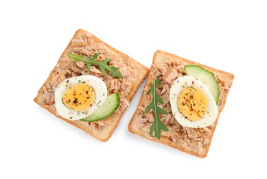 Photo of Delicious sandwiches with tuna, greens, cucumber, boiled egg and spices on white background, top view