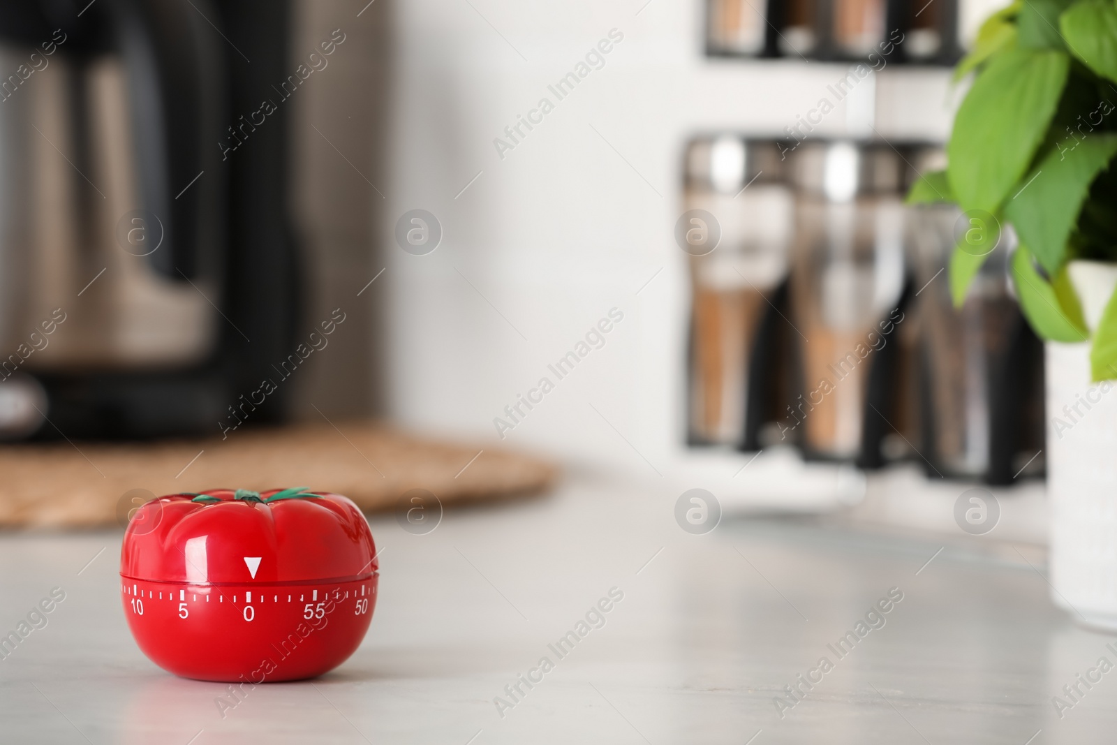 Photo of Kitchen timer in shape of tomato on white table indoors. Space for text