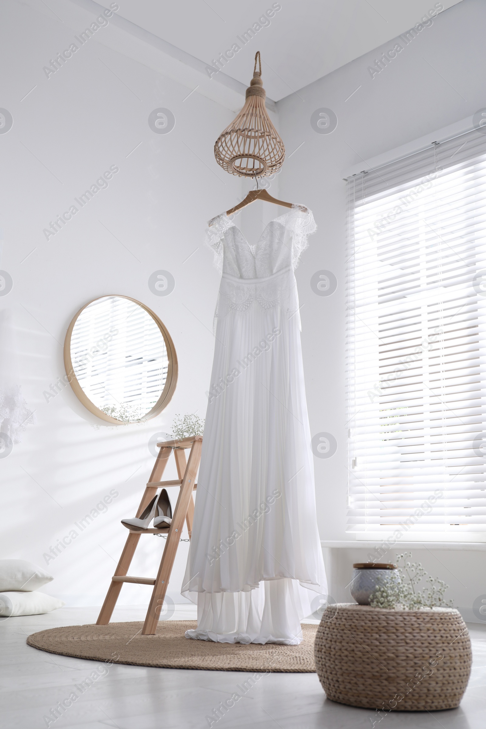 Photo of Beautiful wedding dress, shoes and flowers in room