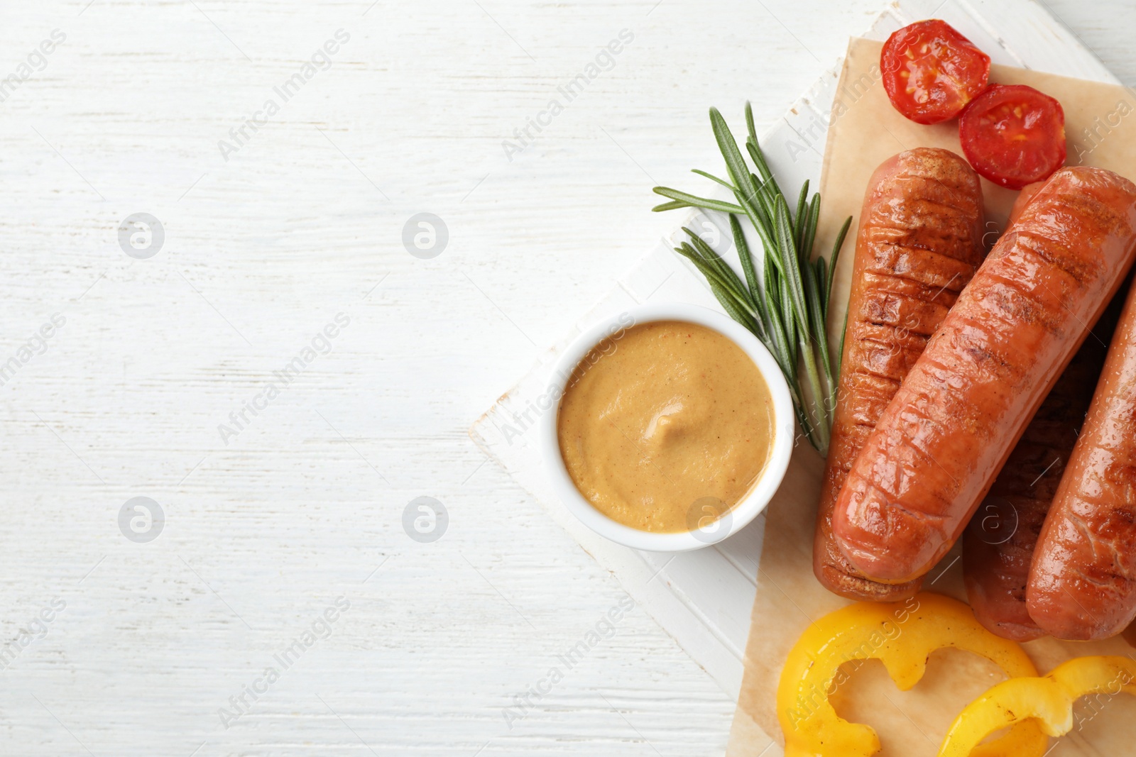 Photo of Flat lay composition with delicious grilled sausages on white wooden table, space for text. Barbecue food