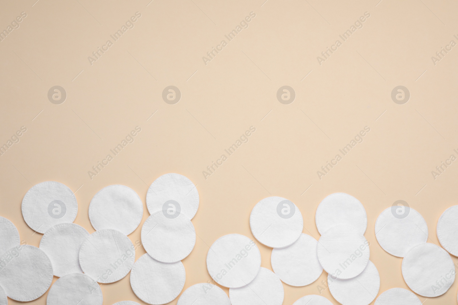 Photo of Many clean cotton pads on yellow background, flat lay. Space for text