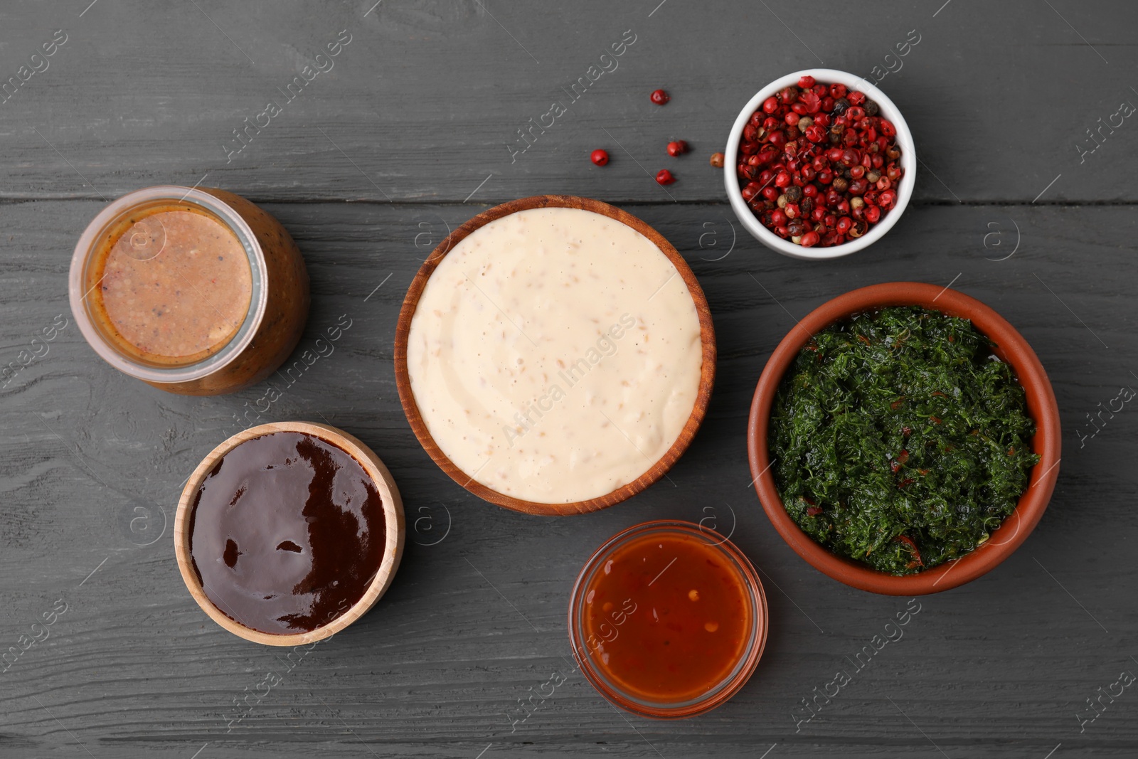 Photo of Different fresh marinades on grey wooden table, flat lay