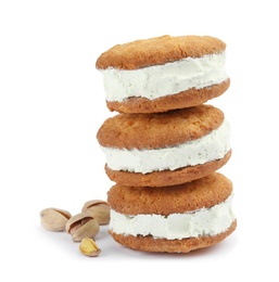 Photo of Sweet delicious ice cream cookie sandwiches and pistachios on white background