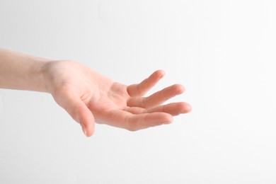 Woman holding hand on white background, closeup