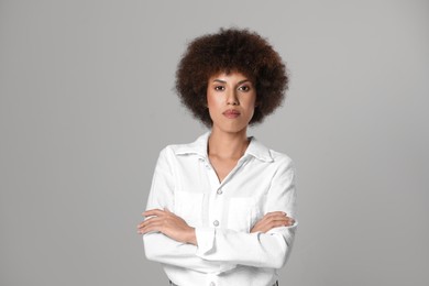 Portrait of beautiful young woman on grey background