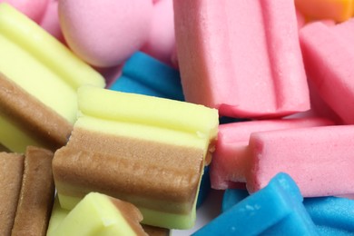 Different tasty colorful bubble gums as background, closeup