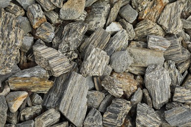 Grey decorative stones as background, top view