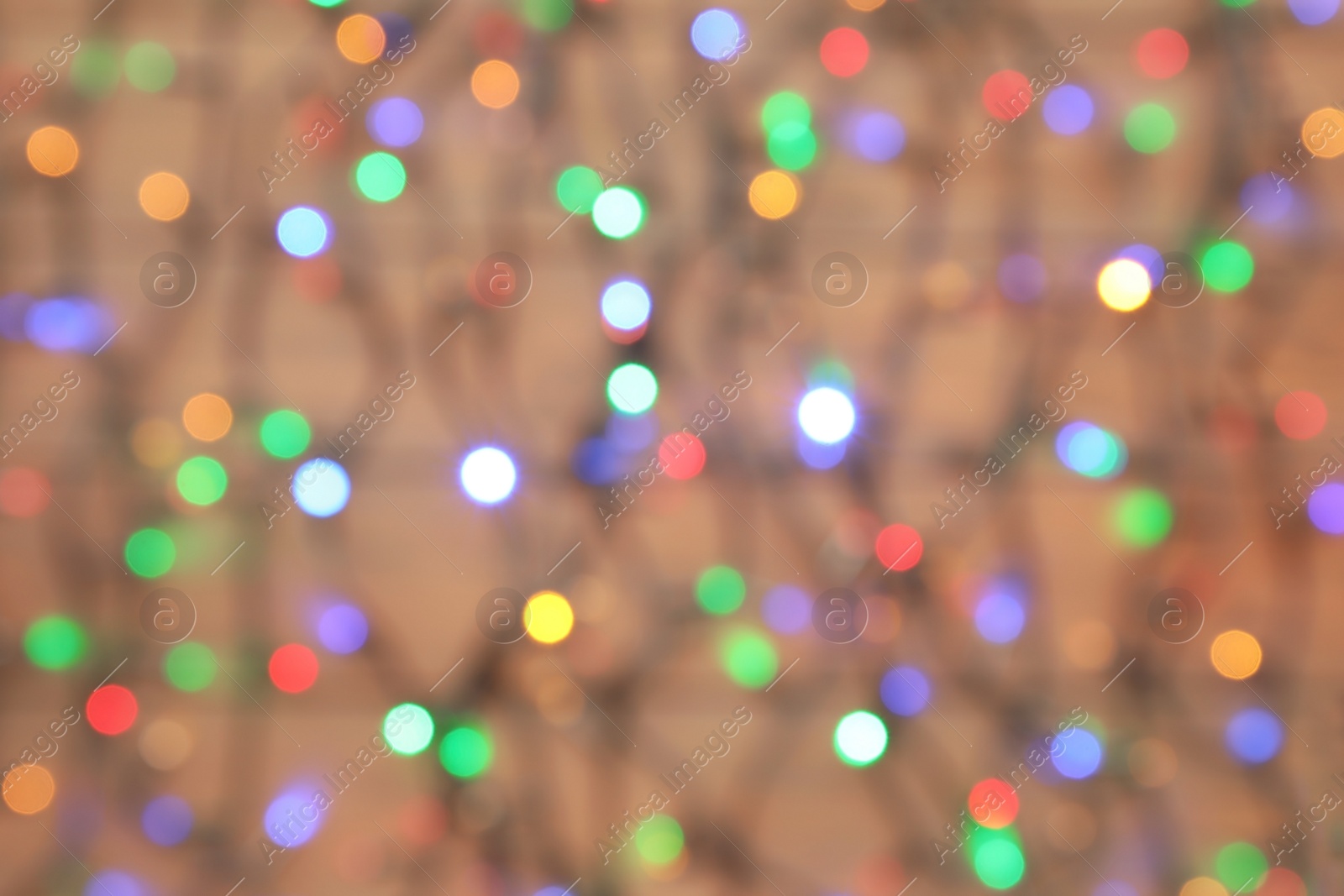 Photo of Blurred view of glowing Christmas lights as background