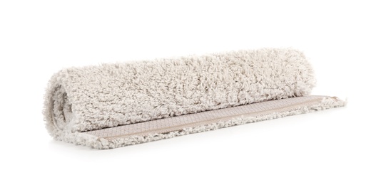 Rolled fuzzy carpet on white background. Interior element