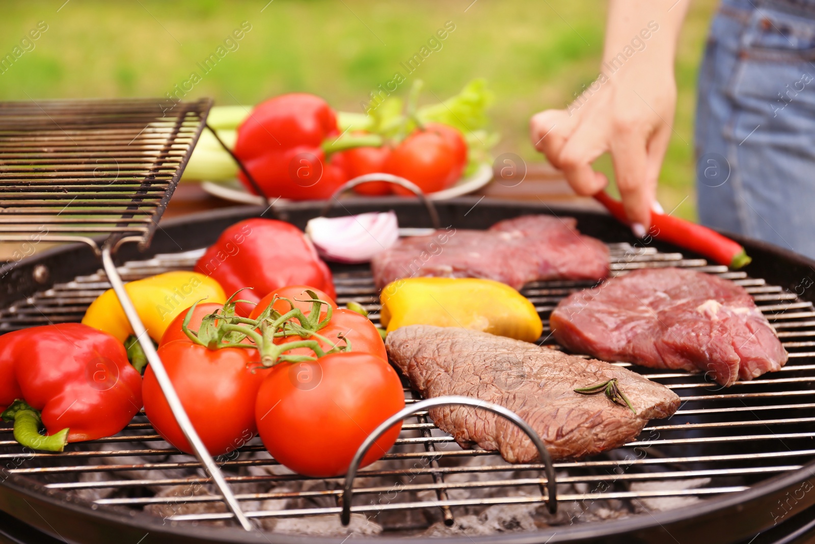 Photo of Modern grill with meat and vegetables outdoors, closeup