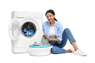 Photo of Beautiful woman with laundry basket near washing machine on white background