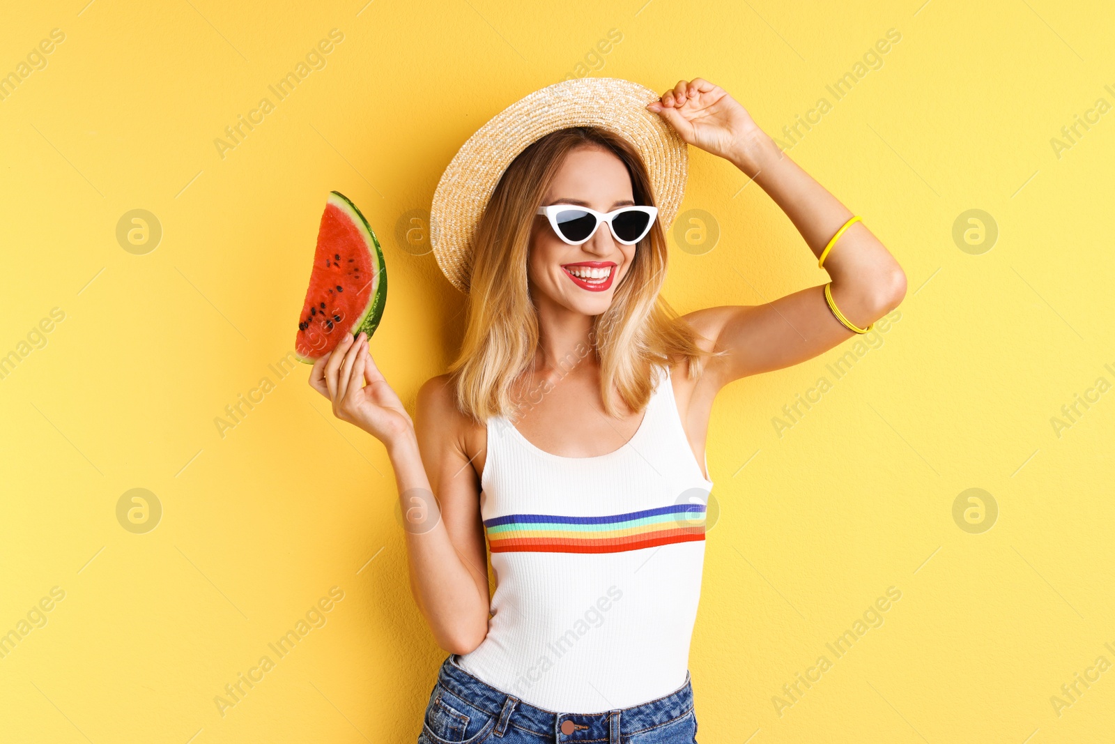 Photo of Pretty young woman with juicy watermelon on color background