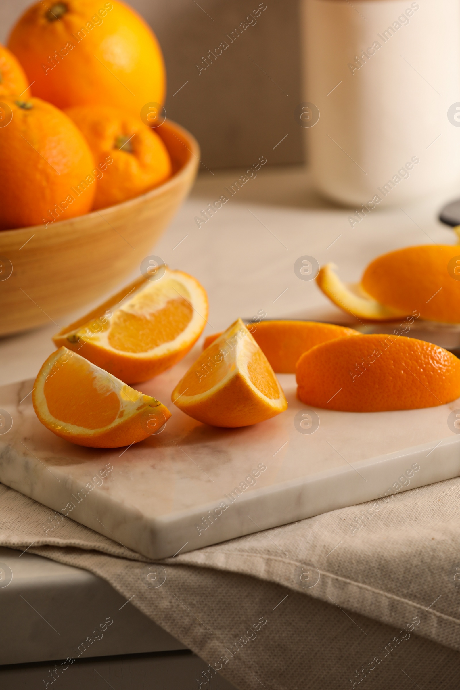 Photo of Fresh orange peels and juicy fruits on white table