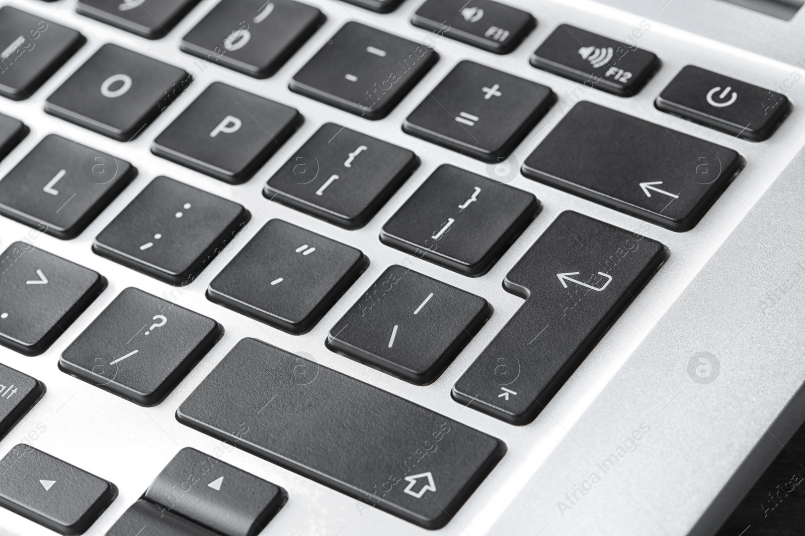 Photo of Modern laptop keyboard with black buttons, closeup view