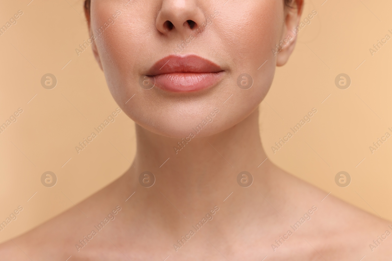 Photo of Woman with beautiful lips on beige background, closeup