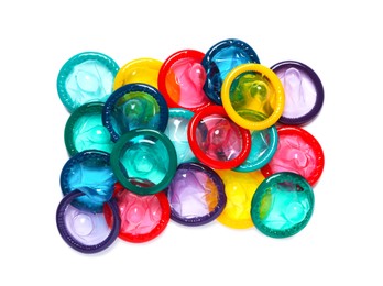 Photo of Colorful condoms isolated on white, top view. Safe sex