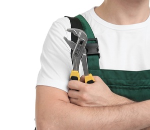 Photo of Young plumber with adjustable wrench on white background, closeup