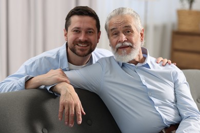 Happy son and his dad at home