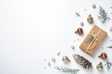 Flat lay composition with Christmas gift and festive decor on white background. Space for text