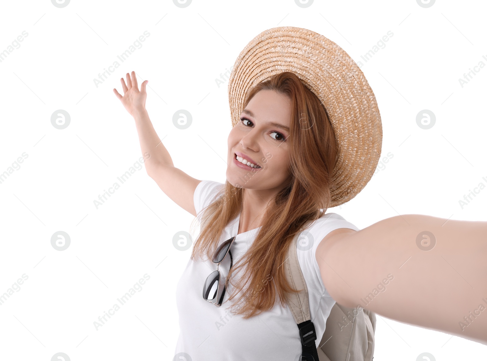 Photo of Beautiful woman in straw hat taking selfie on white background