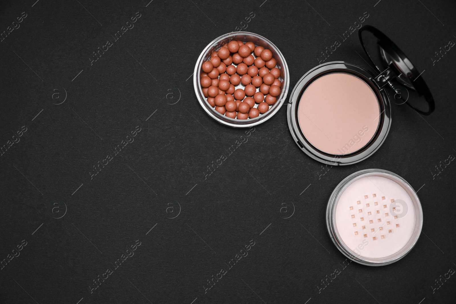 Photo of Different face powders on black background, flat lay. Space for text