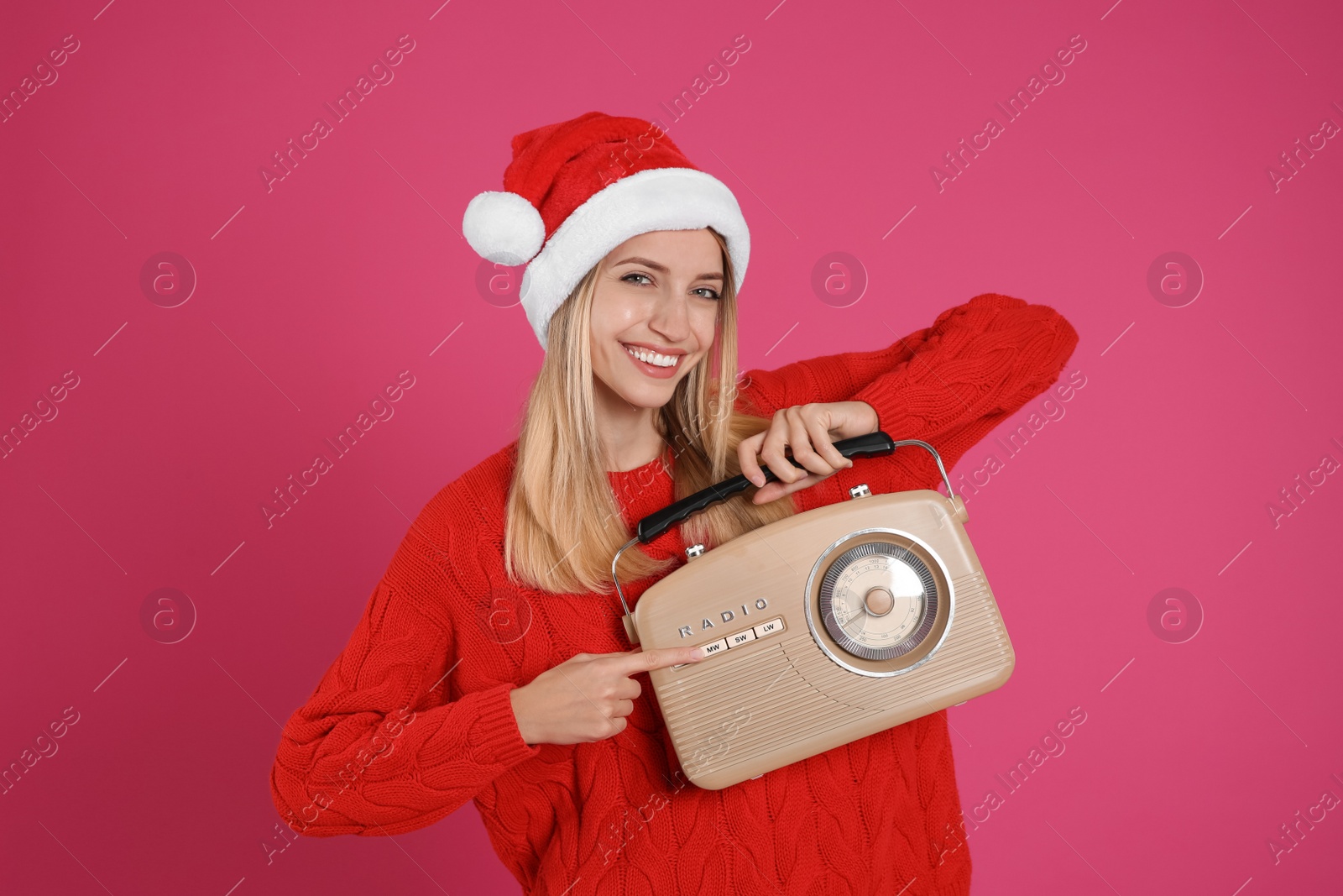 Photo of Happy woman with vintage radio on pink background. Christmas music