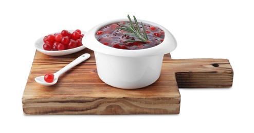 Wooden board with cranberry sauce, fresh berries, spoon and rosemary isolated on white