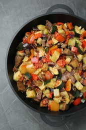 Photo of Delicious ratatouille in baking dish on grey table, top view