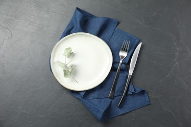 Stylish setting with elegant cutlery on grey textured table, top view